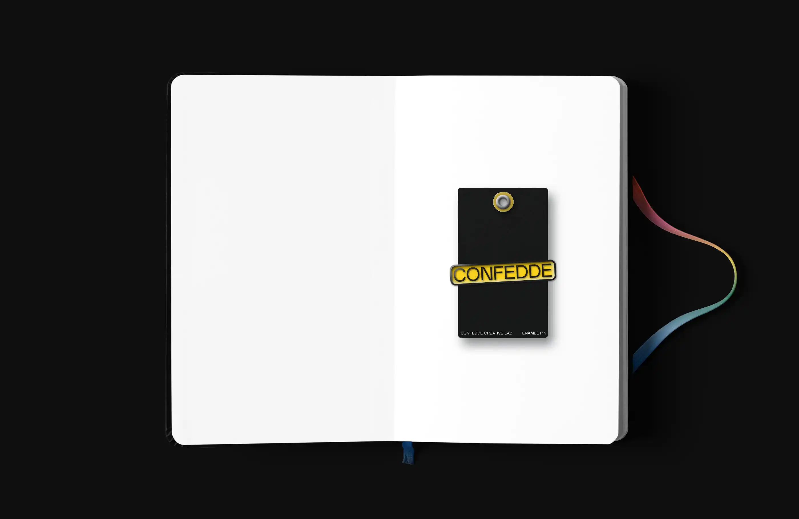 Confedde notebook open to blank page with yellow enamel pin sitting on the page.