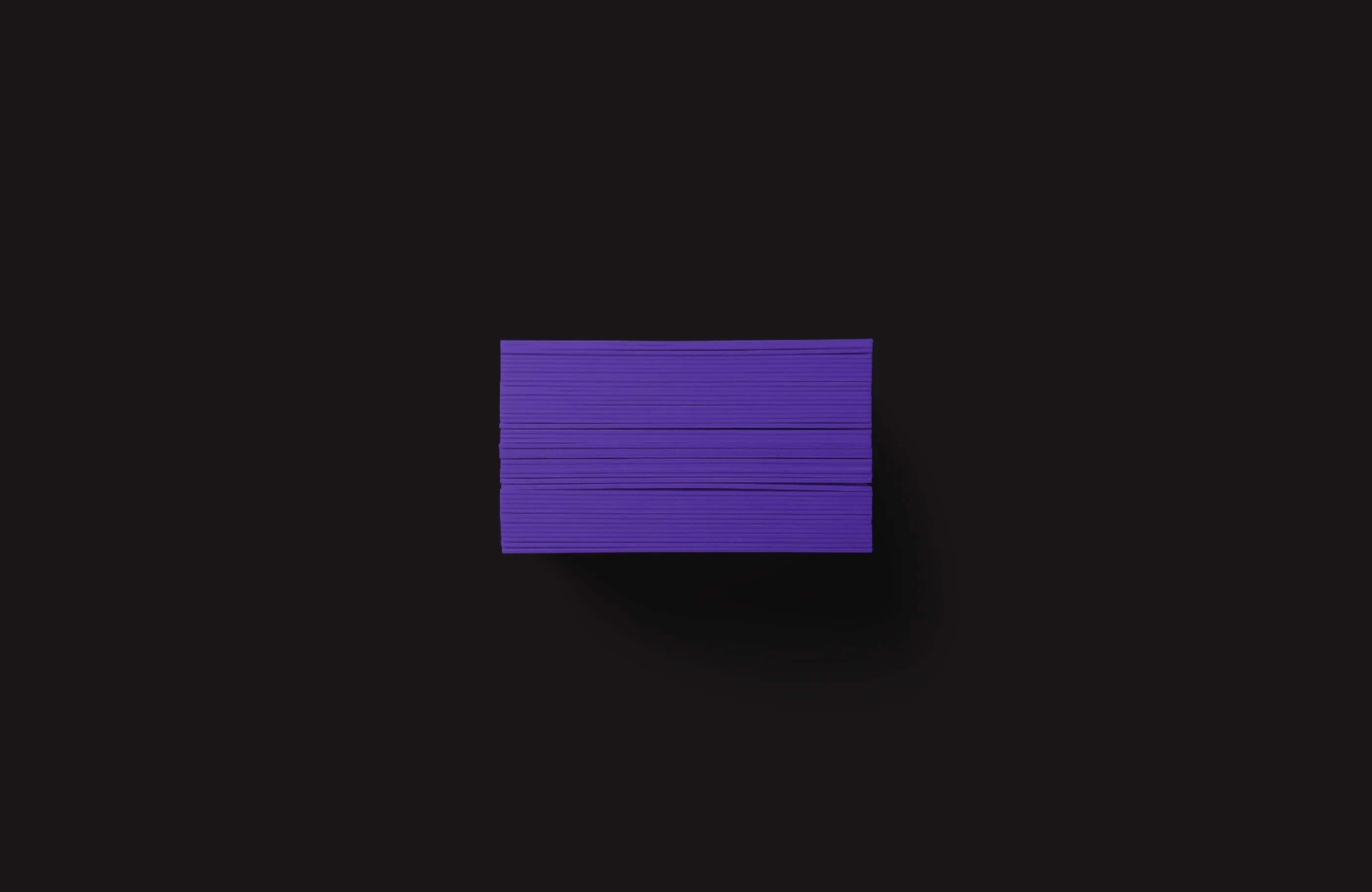Side view of TIMVF business cards showing purple trim.